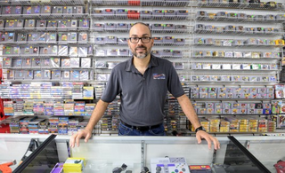 Jerry Robles at the counter in front of the store’s impressive library of classic games.
